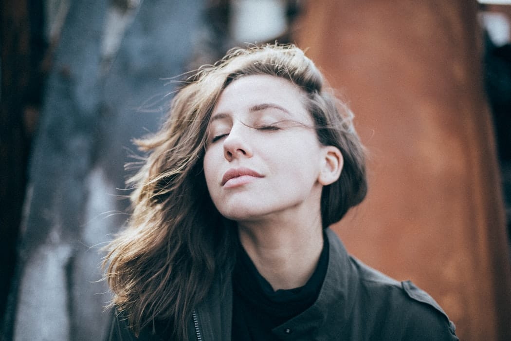 Woman breathing in outside.