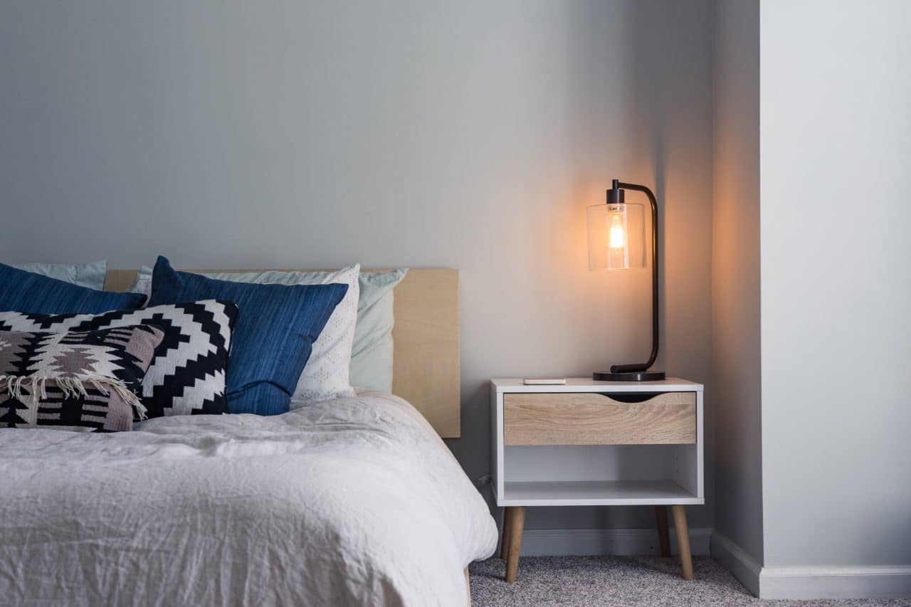 Bedroom with bed and nightstand. 