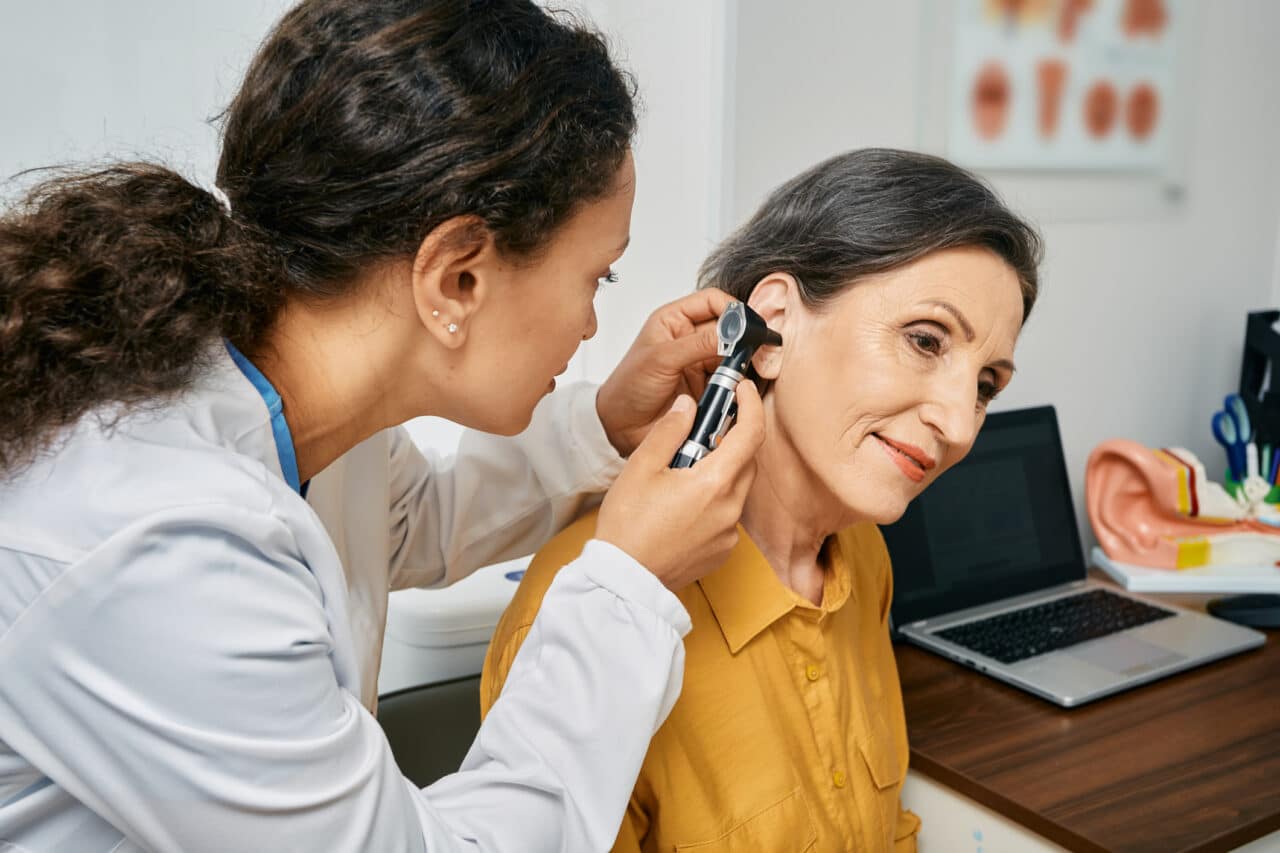 Woman receiving audiology exam.