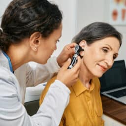 Woman receiving audiology exam.