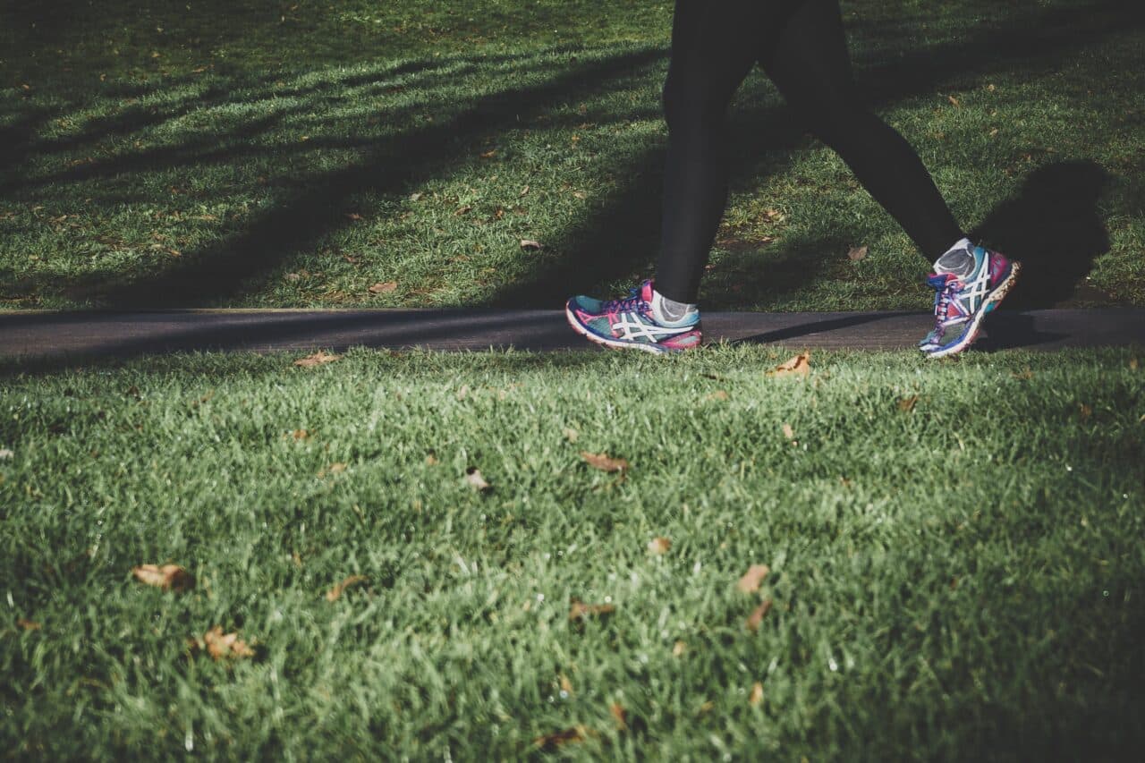 Close-up of a woman jogging outside.