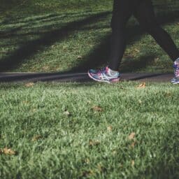 Close-up of a woman jogging outside.
